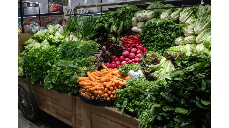 Green vegetables, lettuce leaves and food. The concept of healthy eating, vegetarianism and veganism. Fresh garden farm products grown in ecologically clean places. Vegetarian, vegan and raw food. Without genetically modified products. Market, retail.