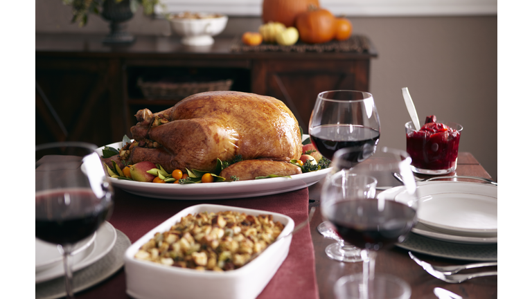 Turkey, stuffing, and cranberry dishes on table.