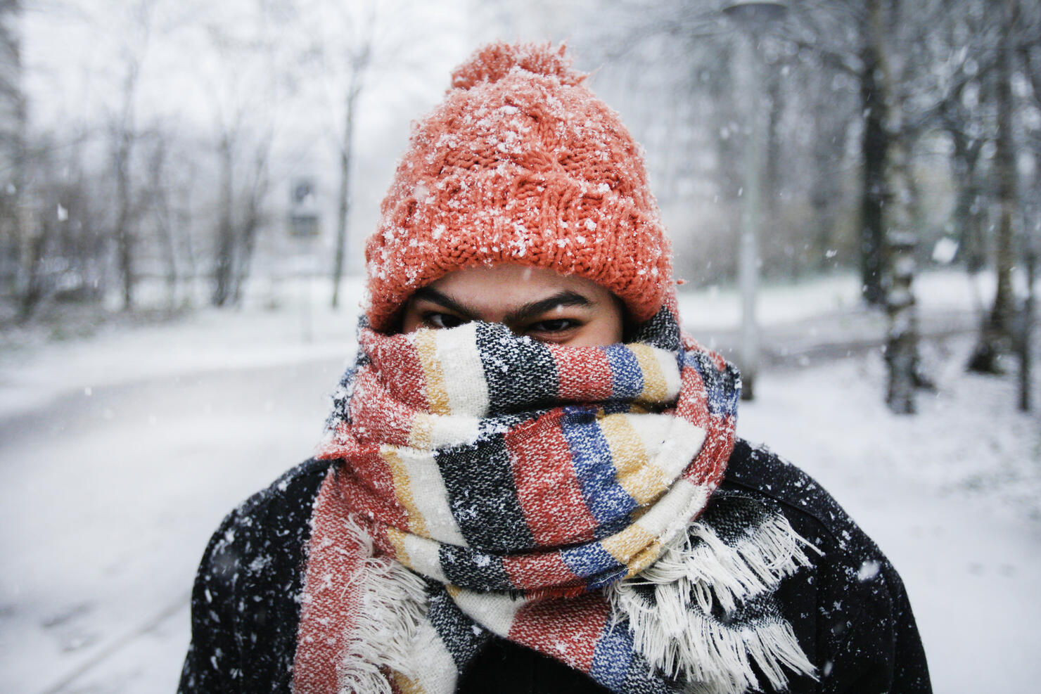 A young woman enjoying snowfall in Amsterdam
