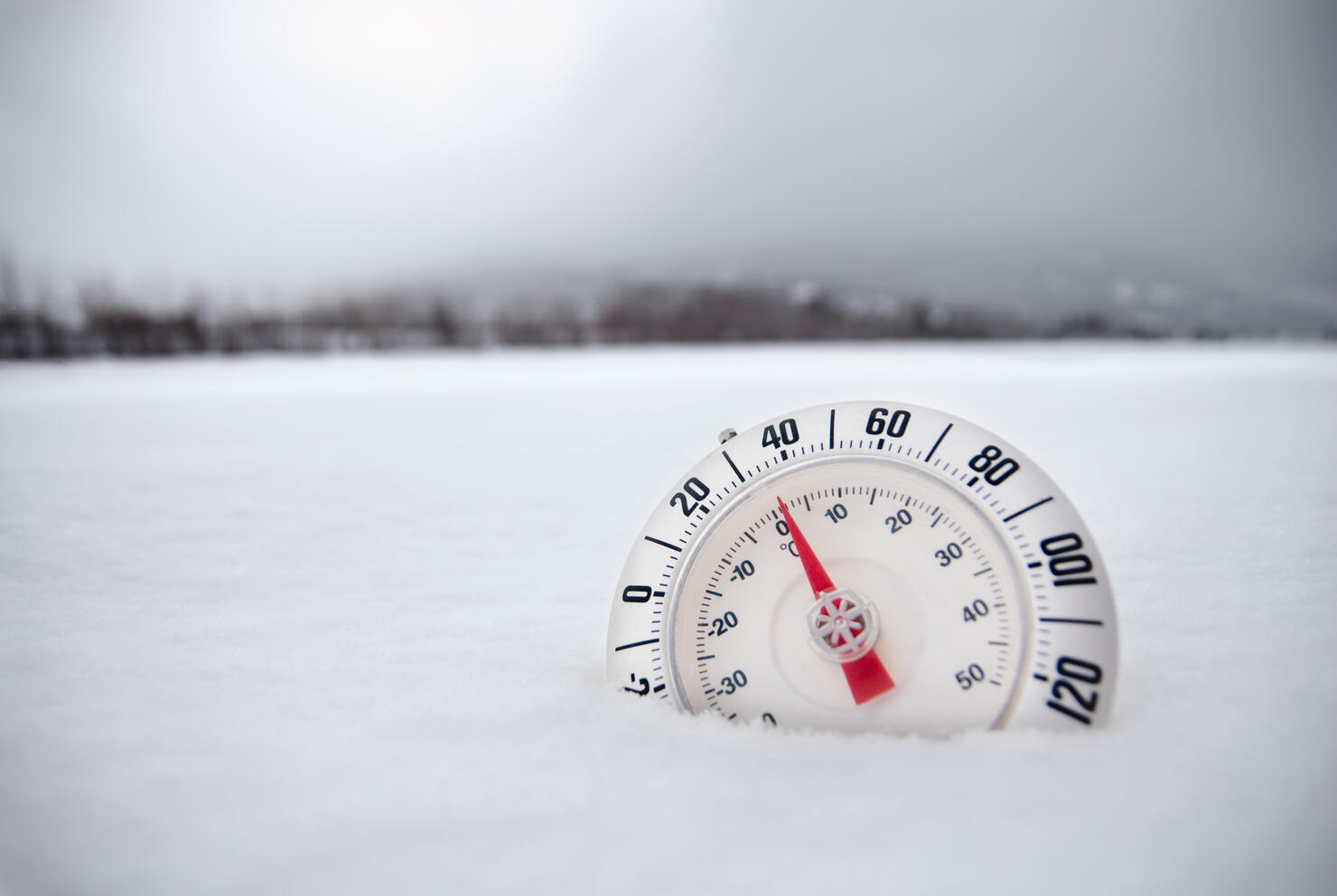 Thermometer in Desolate Winter Snow Tundra