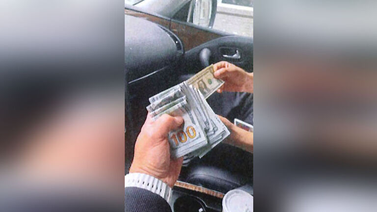 Money is exchanged hands between a suspect and an undercover agent