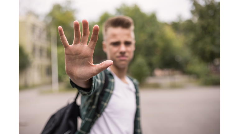 Frustrated teenager putting his hand