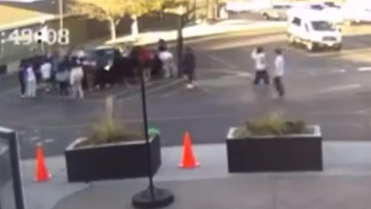 Students Lift a car off of a woman and her child