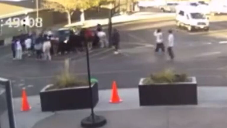 Students Lift a car off of a woman and her child
