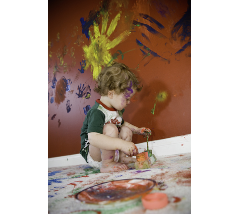 Male toddler (12-15 months) playing with paints