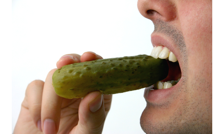 biting a pickle.