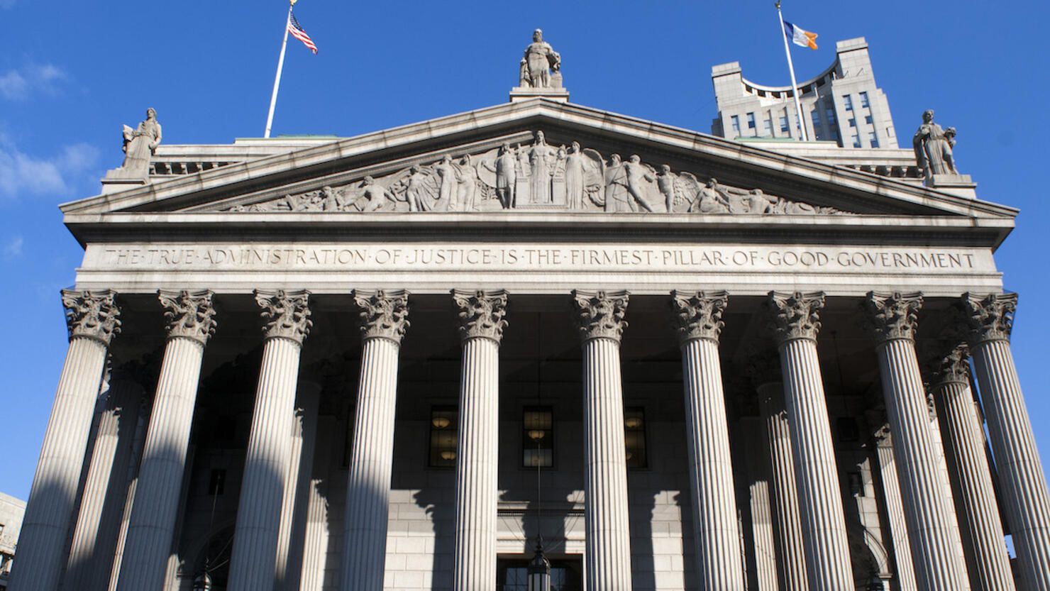 New York State Supreme Court building in Lower Manhattan showing the words 'The True Administration of Justice' on its facade in Manhattan.