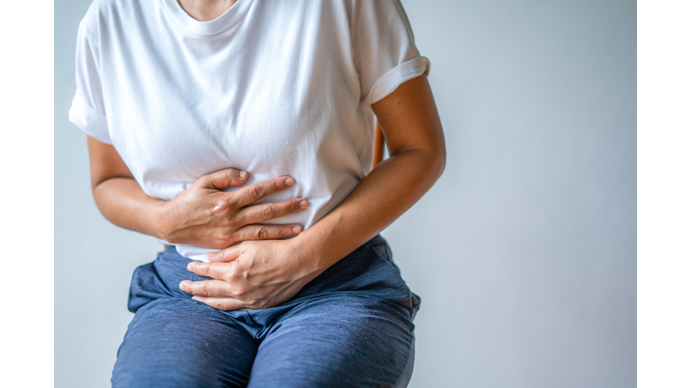 woman with stomach ache, menstrual period cramp, abdominal pain, food poisoning