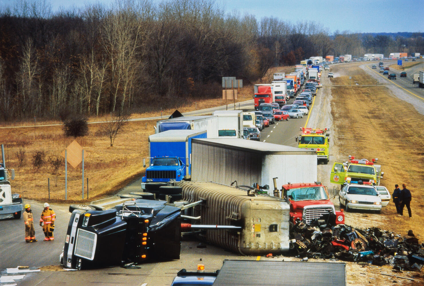 Truck overturned on highway, traffic jam behind