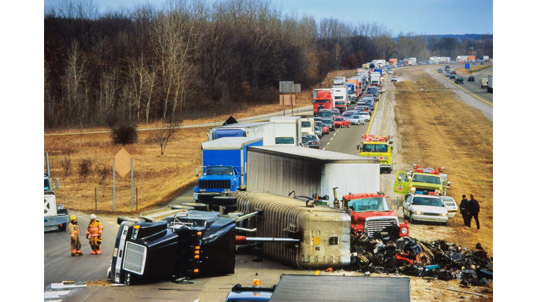 Truck overturned on highway, traffic jam behind