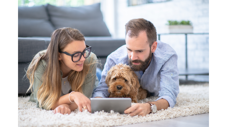 Young couple and their pet dog at home