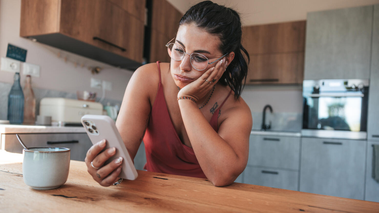 Woman checking phone in the morning having job problems