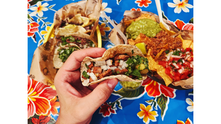 Eating tacos at Mexican restaurant, personal perspective view