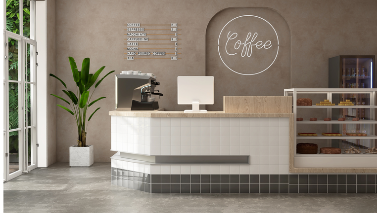Modern, luxury tropical design cafe, wooden counter with espresso machine, cake display fridge in sunlight from outdoor garden on beige brown stucco wall, cement floor