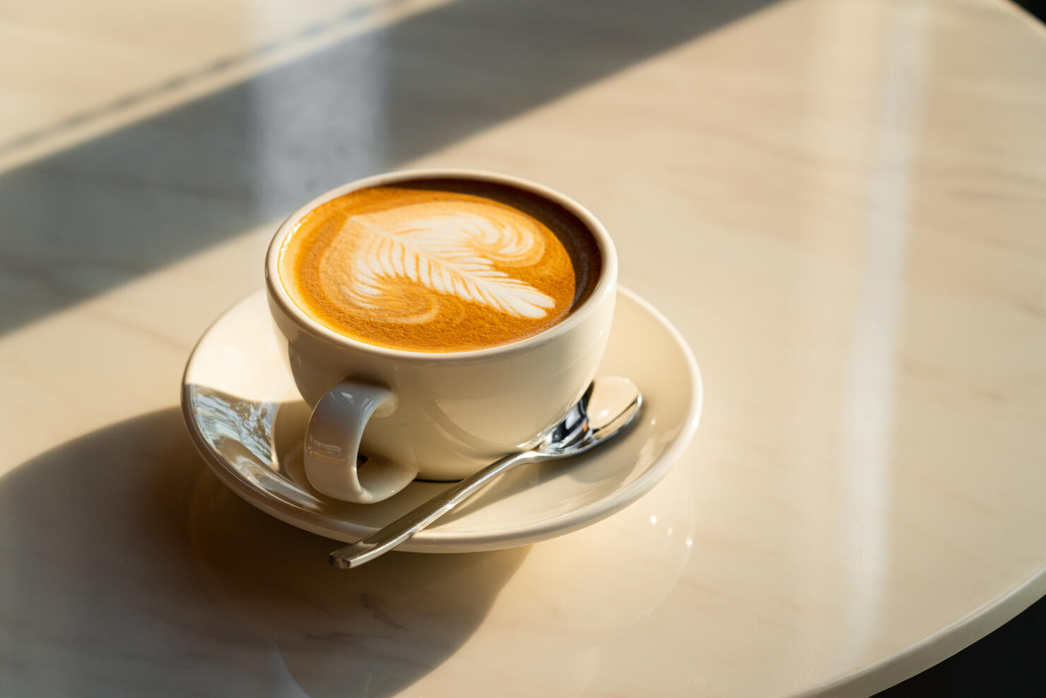 Feshly brewed  latte coffee on a white table