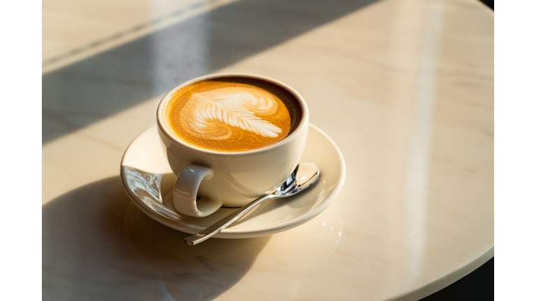 Feshly brewed  latte coffee on a white table