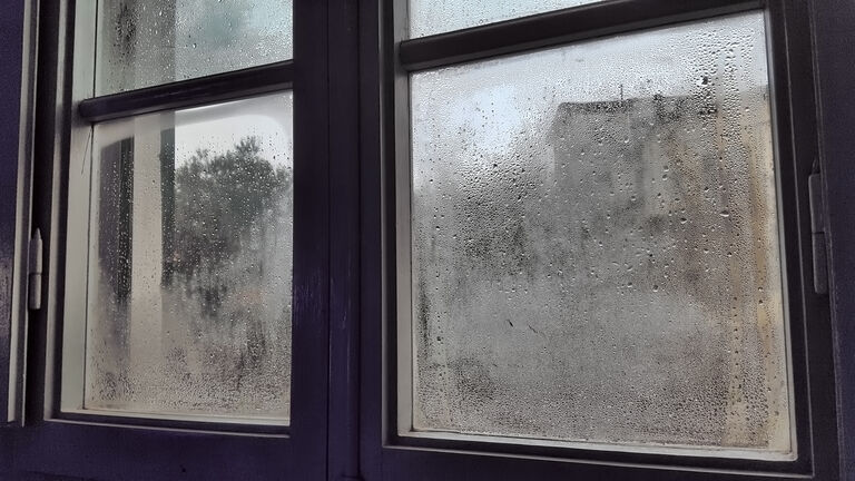 Domestic room with rain droplets on window