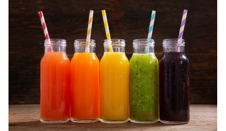 bottles of fruit juice on a wooden table