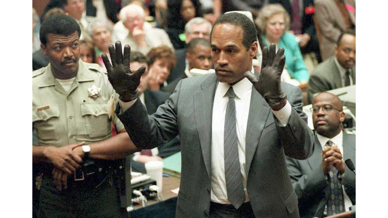 O.J. Simpson shows the jury a new pair of Aris ext