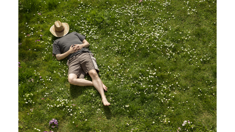 Man lying in grass relaxing