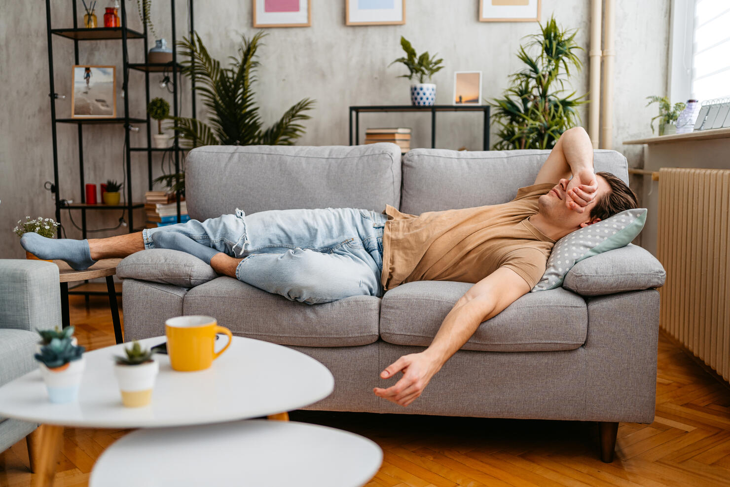 Young Man Sleeping On The Sofa At Home