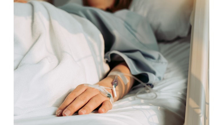 Asian woman lying sick in hospital.