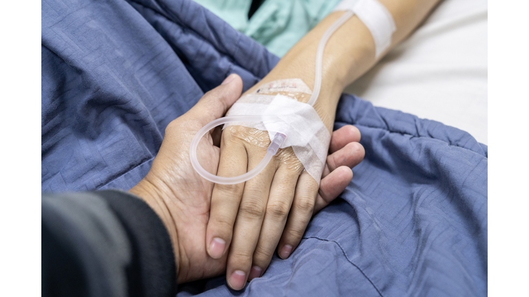 A patient's hand on a recovery bed