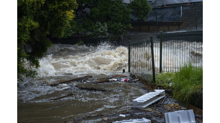 Storm water gushing down the Wairua stream, carrying rubbish along the way. Auckland after the heavy rain.