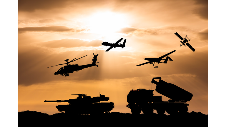 Arms race. Armored tanks, combat drone and missile launcher at sunset.