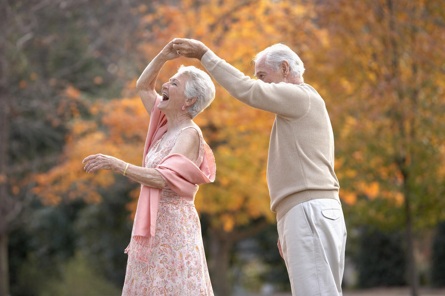 Senior couple dancing outdoors