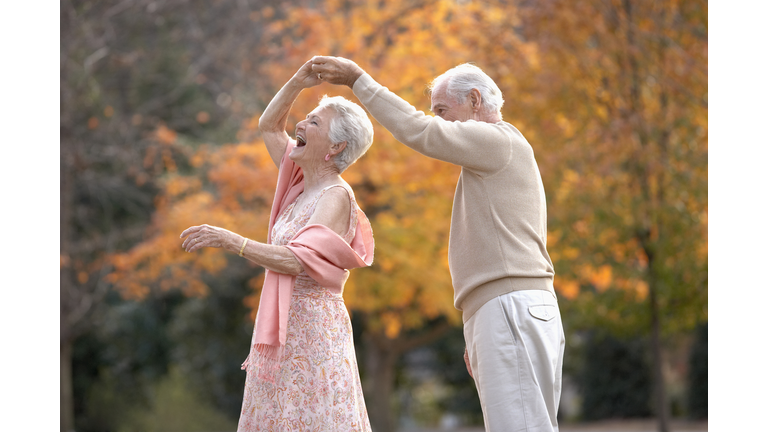 Senior couple dancing outdoors