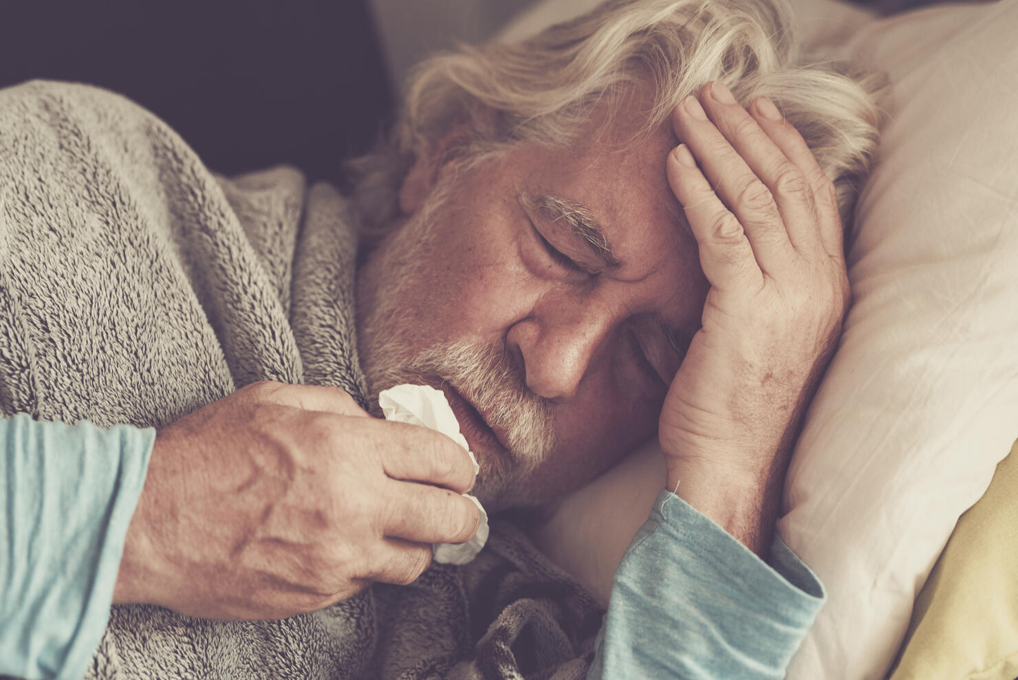 Old people senior man with winter seasonal illness fever cold problems drinking a pharmacy medicine or hot tea to go healthy - concept of mature retired with disease