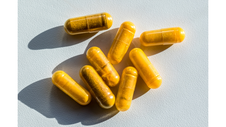 Close-up of turmeric capsules on table