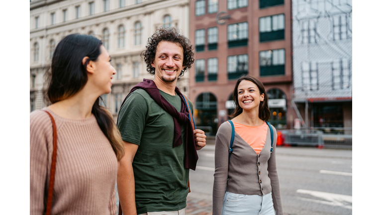 Three Young Friends Walking On The Street In Malmo In Sweden