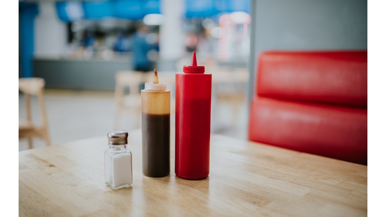 Condiment bottles on a table in a diner