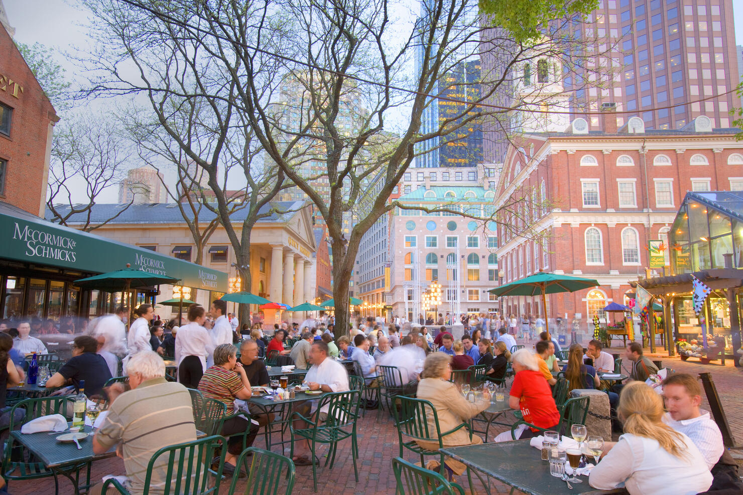 People having breakfast at pavement cafT, Faneuil hall in background
