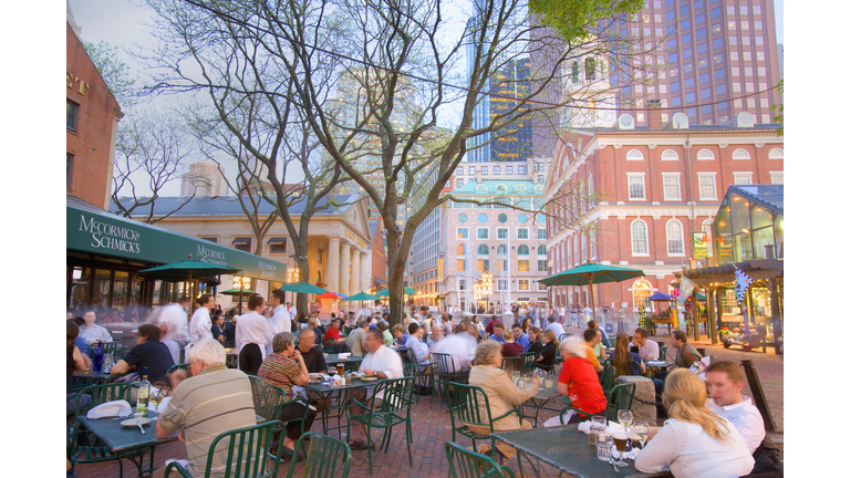 People having breakfast at pavement cafT, Faneuil hall in background
