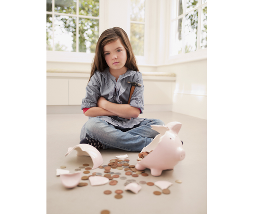 Frustrated girl sitting with broken piggy bank