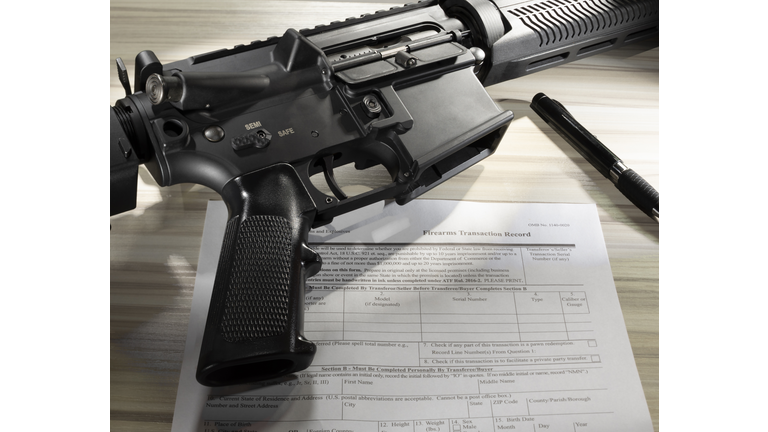 Public domain background check form with assault rifle