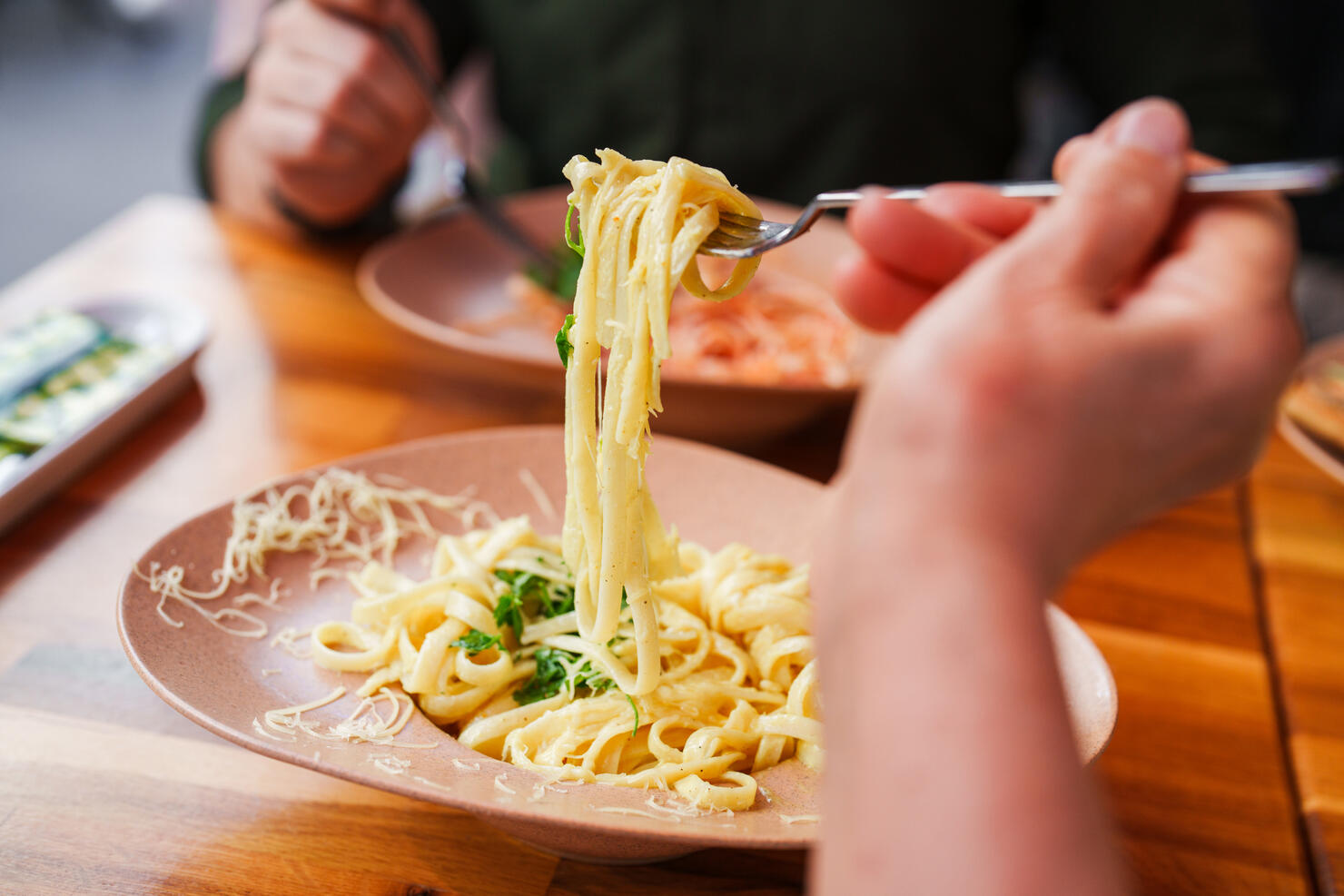Selective focus to a bowl of fettuccine alfredo