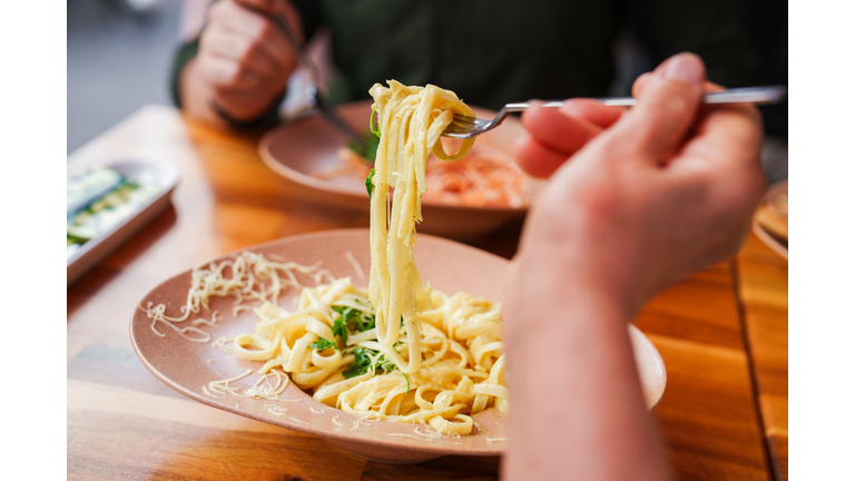 Selective focus to a bowl of fettuccine alfredo