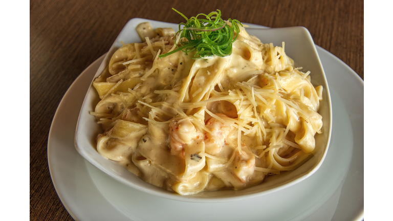 Creamy shrimp tagliatelle pasta in a bowl on a plate