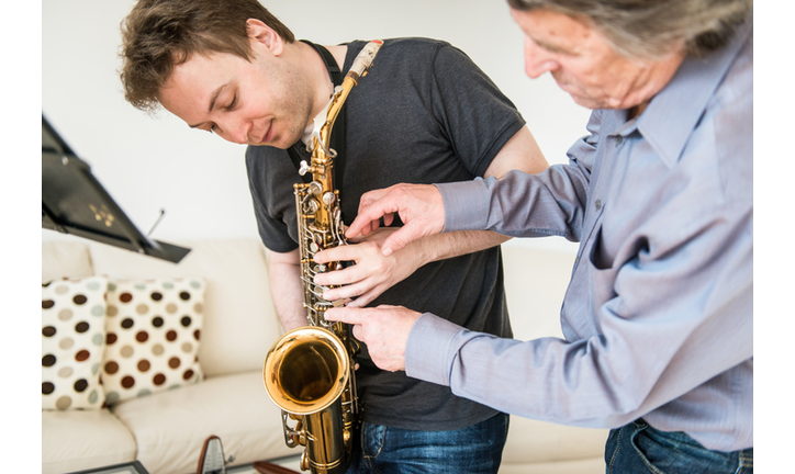 Young Man Learning to Play Saxophone at Home