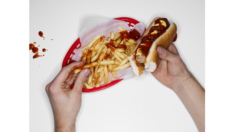Messy eating, hot dog and fries, overhead view