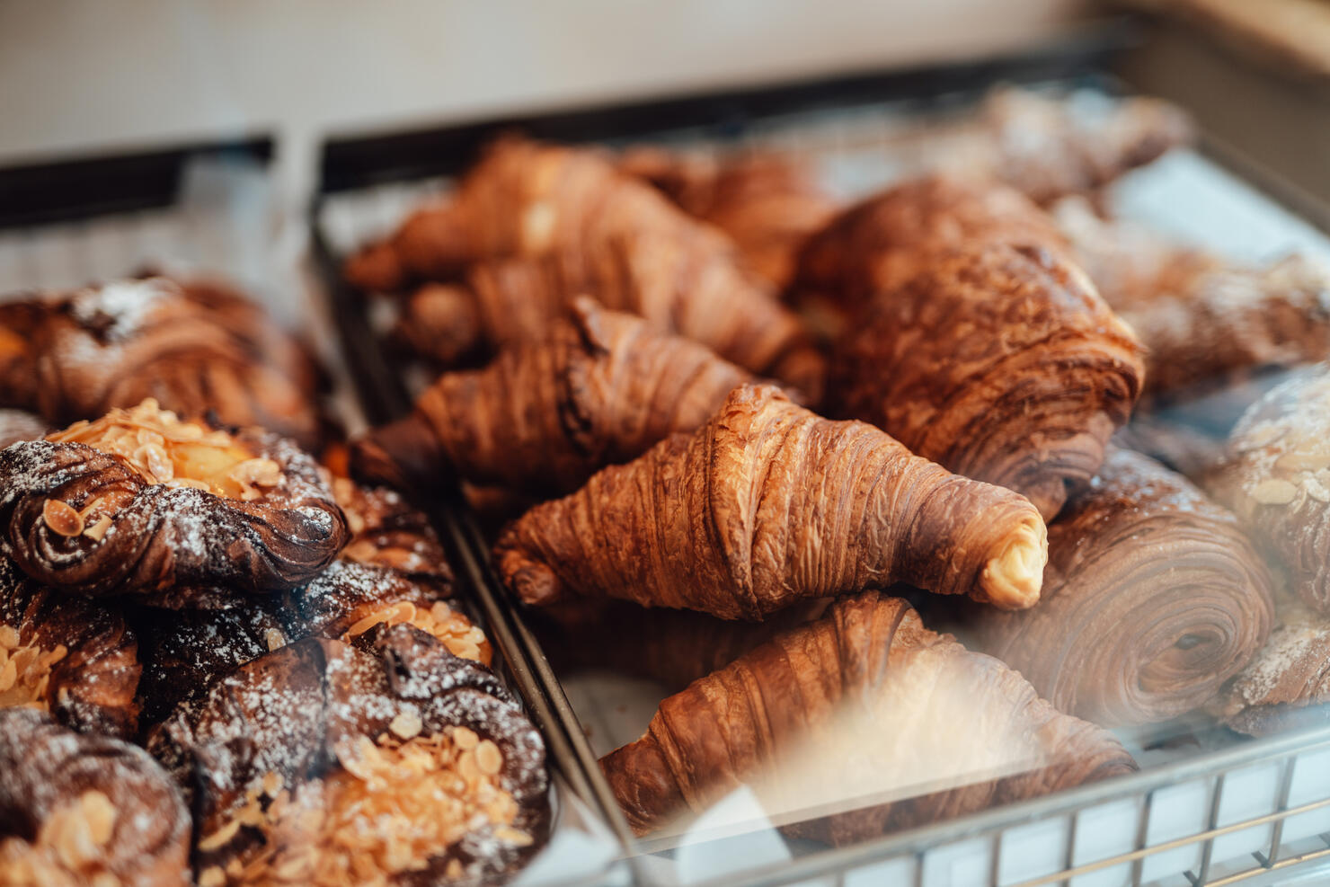 Close-up of fresh French baked pastry in the display cabinet in a cafe.
