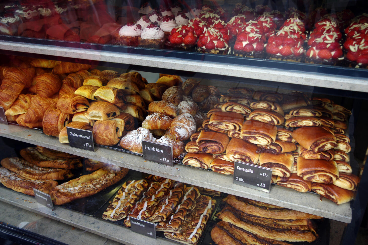 Sweet baked items for sale in the window of a bakery in Copenhagen, Denmark