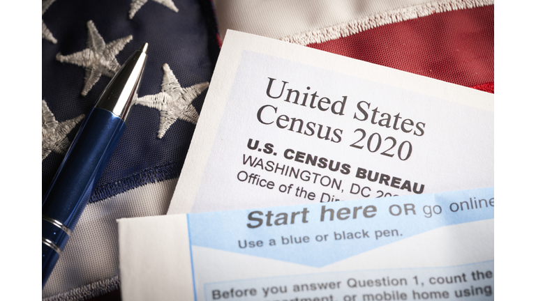 Census 2020: survey questionnaire form on desk with pen and usa flag