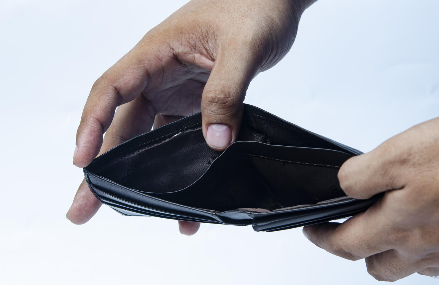 Empty wallet (no money) in the hands of an Businessman