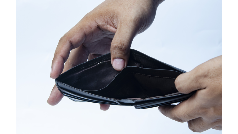 Empty wallet (no money) in the hands of an Businessman