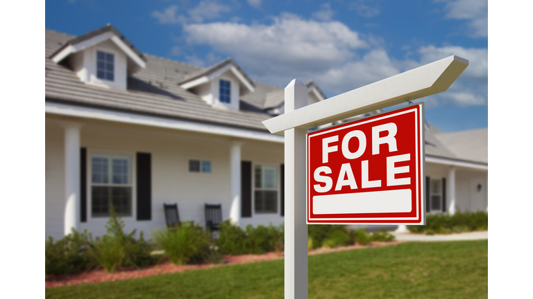 For Sale Real Estate Sign in Front of New House.